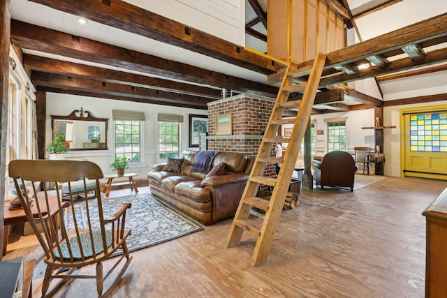 living room with baseboard heating, hardwood / wood-style floors, and beamed ceiling