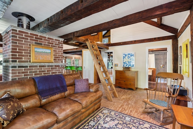 living room with beamed ceiling, hardwood / wood-style floors, and a wood stove