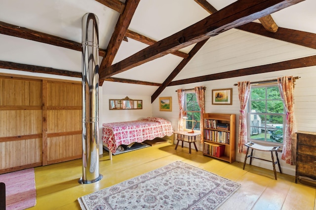 bedroom featuring light hardwood / wood-style flooring and lofted ceiling with beams