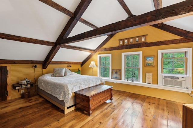 bedroom featuring lofted ceiling with beams, wood-type flooring, wooden walls, and cooling unit