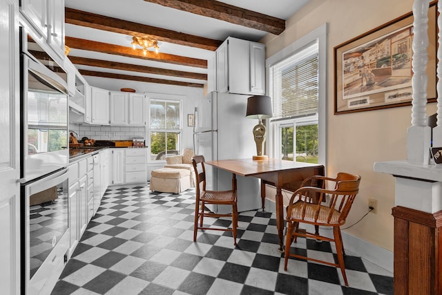 kitchen with white cabinetry, beverage cooler, beamed ceiling, and tasteful backsplash