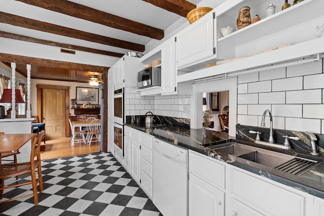 kitchen with white cabinetry, tasteful backsplash, dishwasher, beam ceiling, and sink