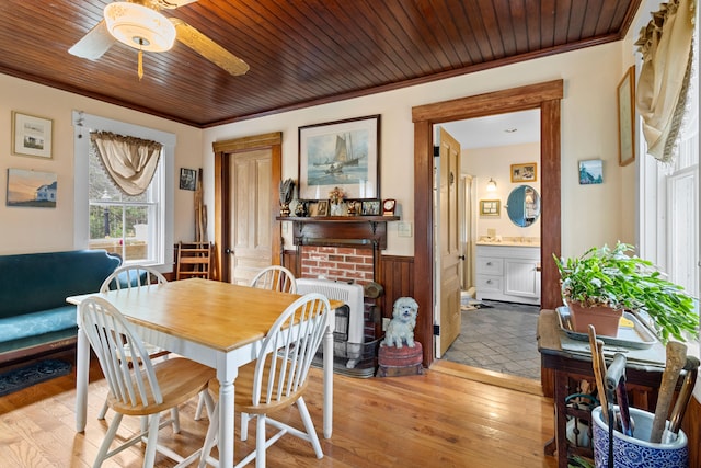 dining room featuring ceiling fan, wood ceiling, crown molding, and light hardwood / wood-style floors