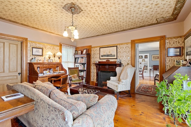 living room with an inviting chandelier and light hardwood / wood-style floors