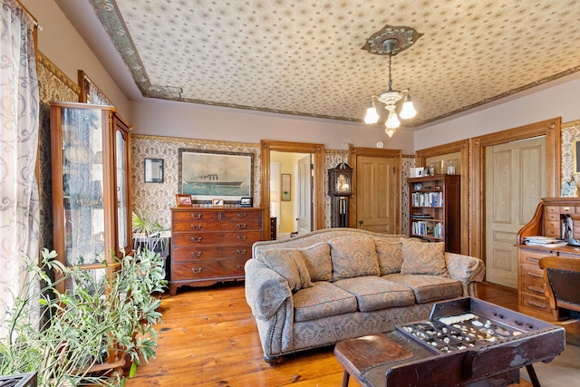 living room with a notable chandelier and light wood-type flooring