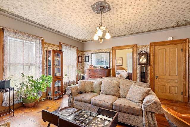 living room with hardwood / wood-style flooring and a notable chandelier