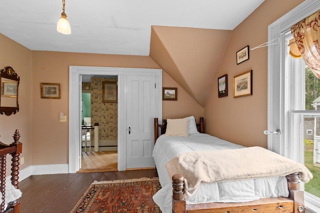 bedroom with vaulted ceiling and dark hardwood / wood-style flooring