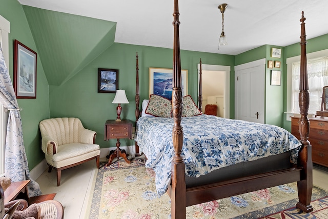 bedroom featuring wood-type flooring and vaulted ceiling