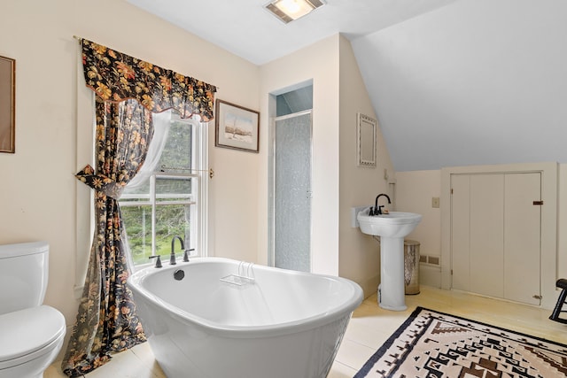 bathroom with independent shower and bath, vaulted ceiling, toilet, and tile patterned floors