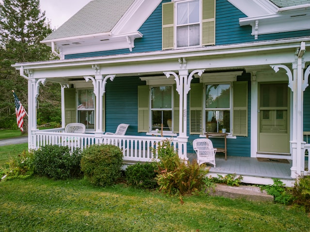 exterior space with a porch and a yard