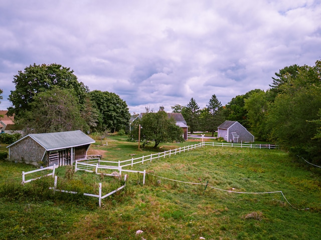 view of yard with a rural view and an outbuilding