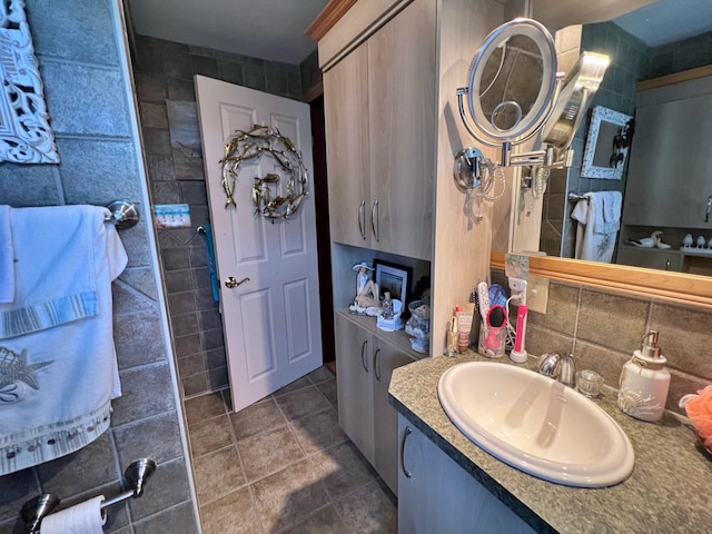 bathroom with tile walls, backsplash, vanity, and tile patterned flooring