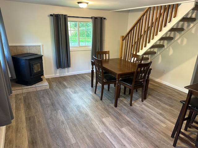 dining area featuring a wood stove and dark hardwood / wood-style flooring