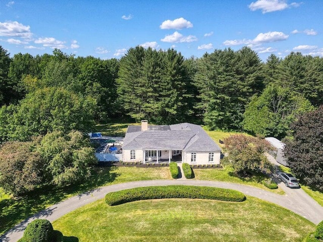 drone / aerial view with a wooded view