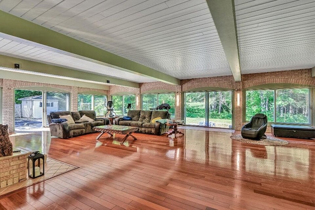 living room with beamed ceiling and hardwood / wood-style floors