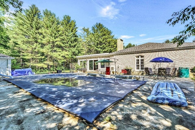 exterior space featuring a covered pool, a pergola, and a patio