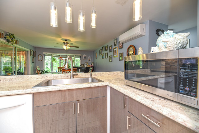 kitchen with ceiling fan, hanging light fixtures, sink, dishwasher, and a wall unit AC