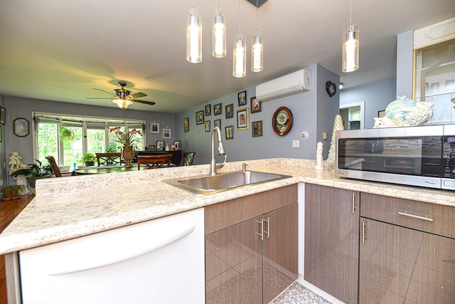 kitchen with ceiling fan, sink, dishwasher, hanging light fixtures, and a wall mounted AC