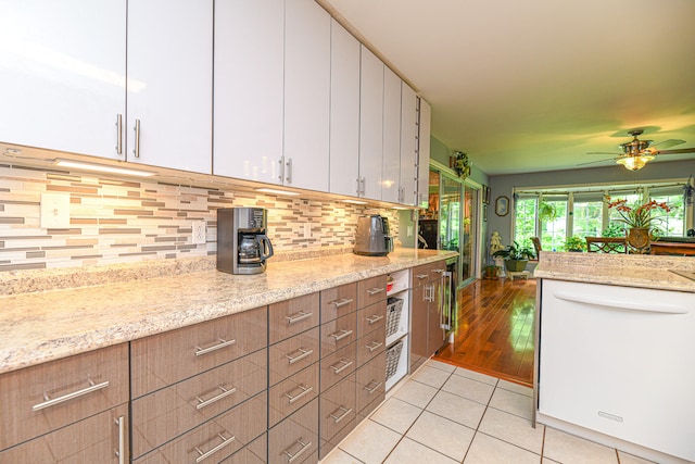 kitchen featuring light stone counters, ceiling fan, light hardwood / wood-style floors, and white cabinets