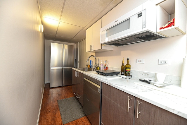 kitchen featuring sink, dark brown cabinets, white cabinetry, dishwasher, and dark hardwood / wood-style flooring