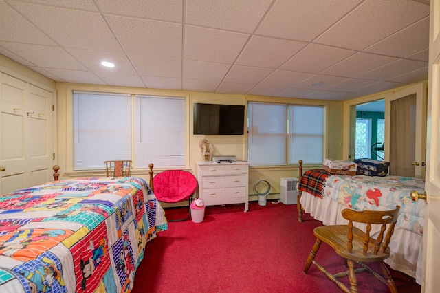 bedroom featuring a paneled ceiling and carpet flooring