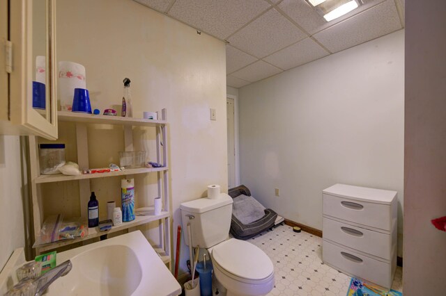 bathroom with a drop ceiling and toilet