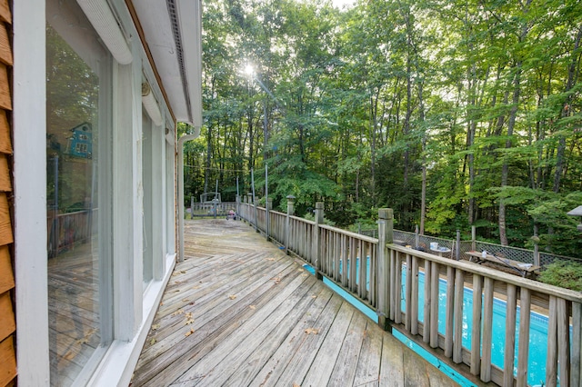 wooden terrace featuring a swimming pool