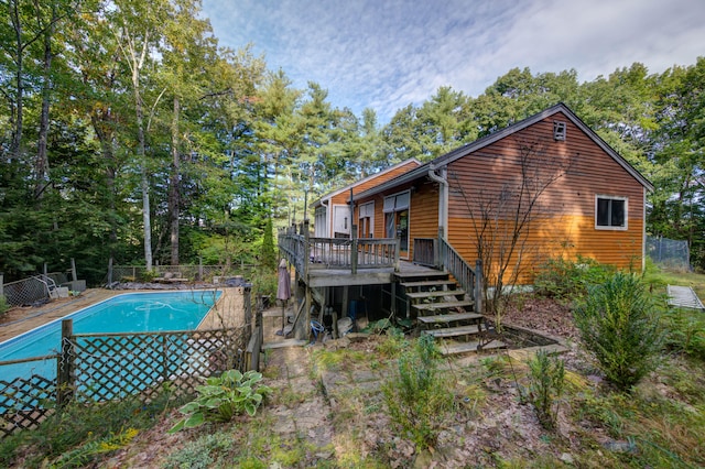 back of house featuring a pool side deck