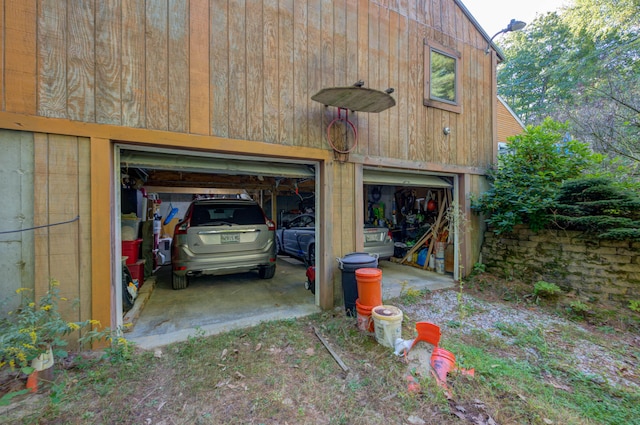 garage featuring wood walls