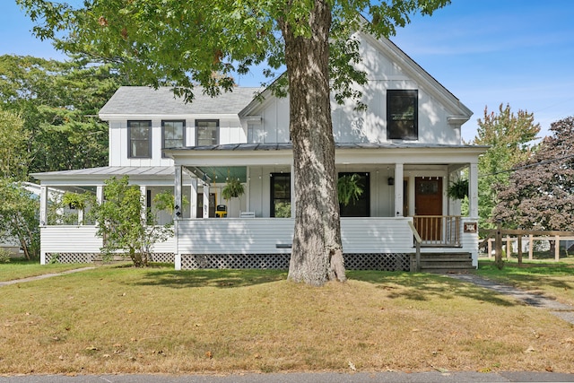 view of front of house featuring a front lawn and covered porch