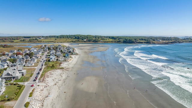 birds eye view of property with a water view and a view of the beach