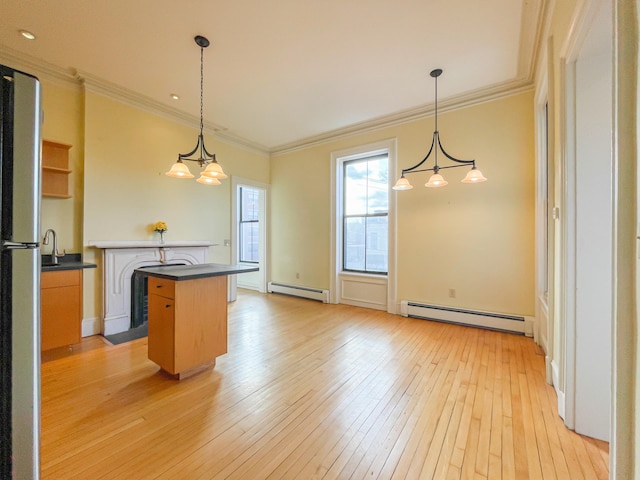 kitchen featuring a center island, hanging light fixtures, a baseboard heating unit, and light hardwood / wood-style flooring