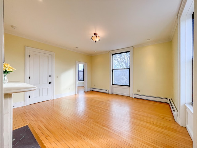 unfurnished room featuring ornamental molding, a baseboard heating unit, and light hardwood / wood-style floors