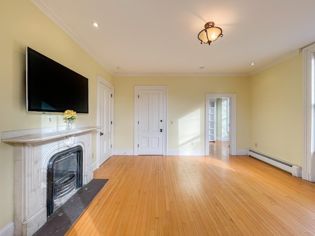 unfurnished living room with ornamental molding, baseboard heating, and light wood-type flooring