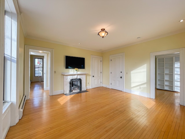 unfurnished living room with ornamental molding, light hardwood / wood-style flooring, a fireplace, and baseboard heating