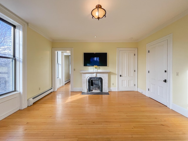 unfurnished living room featuring crown molding, a baseboard heating unit, and light wood-type flooring