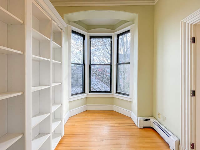 interior space with light wood-type flooring and a baseboard radiator