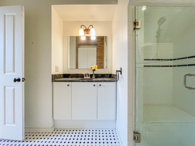 bathroom with tile patterned floors, vanity, and a shower with shower door