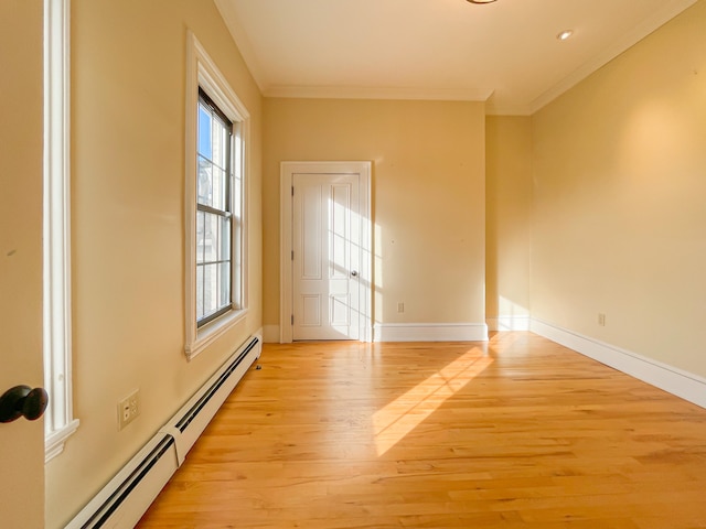 unfurnished room featuring light hardwood / wood-style floors, crown molding, and a baseboard radiator