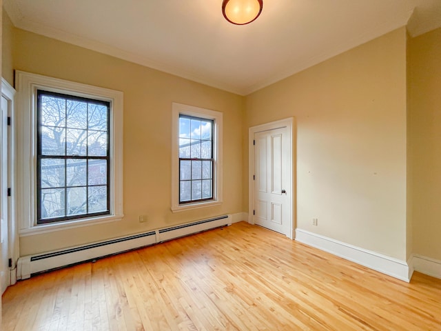 unfurnished room featuring light wood-type flooring, crown molding, and baseboard heating