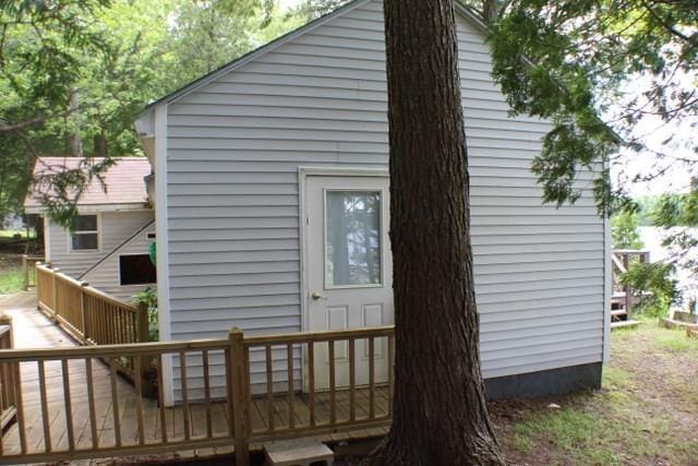 view of side of home with a wooden deck