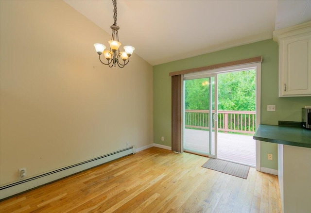 unfurnished dining area featuring light wood-type flooring, vaulted ceiling, baseboard heating, and a chandelier