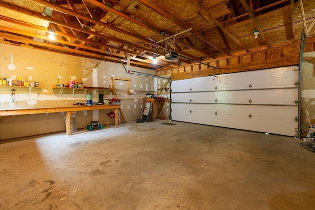 garage with a garage door opener and a workshop area