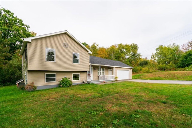 tri-level home featuring a garage and a front yard