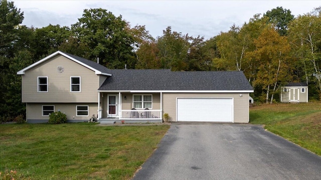 split level home with a garage, a porch, a front lawn, and a storage unit