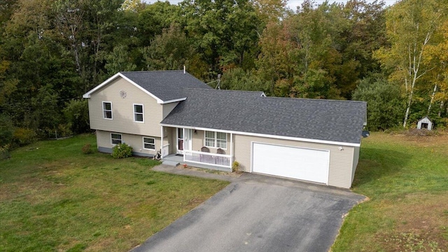 tri-level home with a front yard, a porch, and a garage