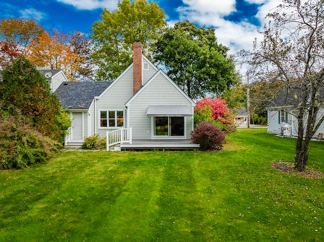 rear view of property featuring a lawn