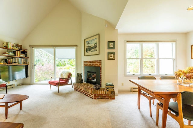 living room with a healthy amount of sunlight, light carpet, and a brick fireplace