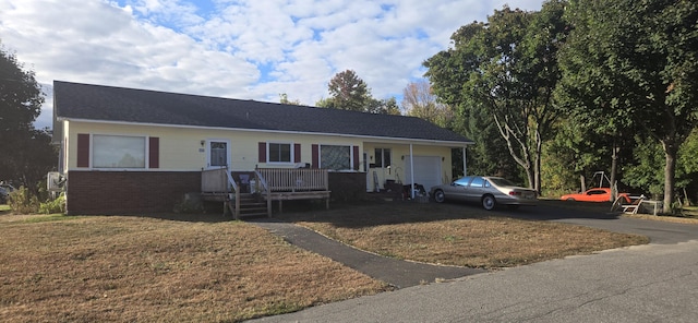 60 Elm St, East Millinocket, ME 04430 - ranch-style home with a garage, asphalt driveway, and brick siding