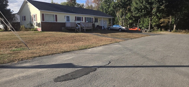 60 Elm St, East Millinocket, ME 04430 - single story home with brick siding, a front lawn, and driveway